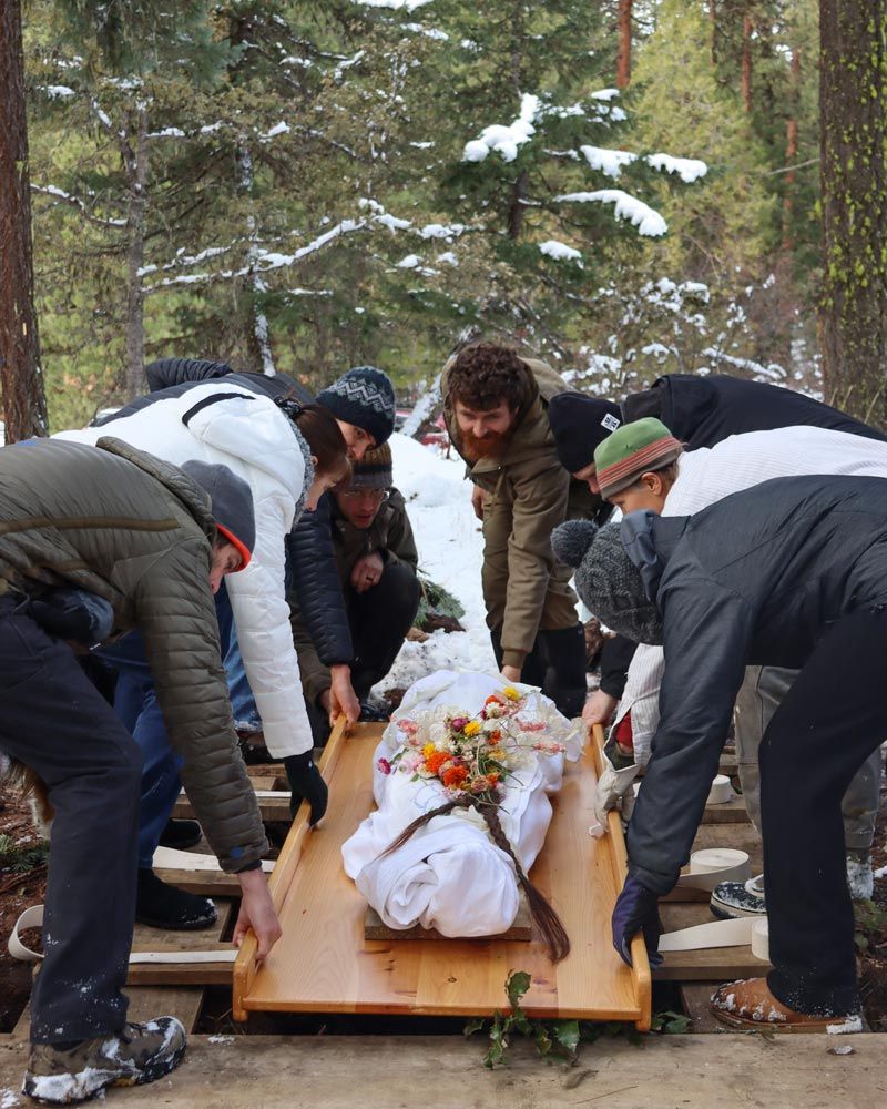 green burial with body wrapped in shroud with flowers