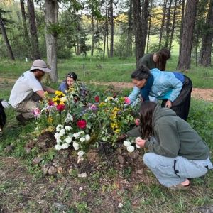 placing flowers on the green burial site of Dr. Lanita Witt