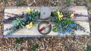 funeral flowers and sound bowl at a green burial