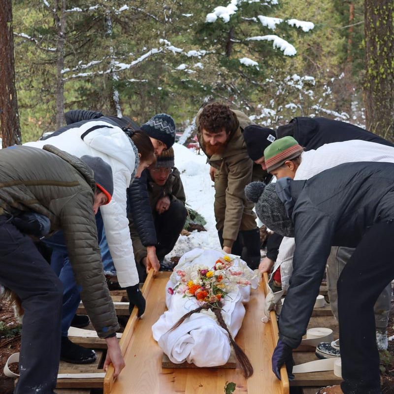 green burial with body wrapped in shroud with flowers